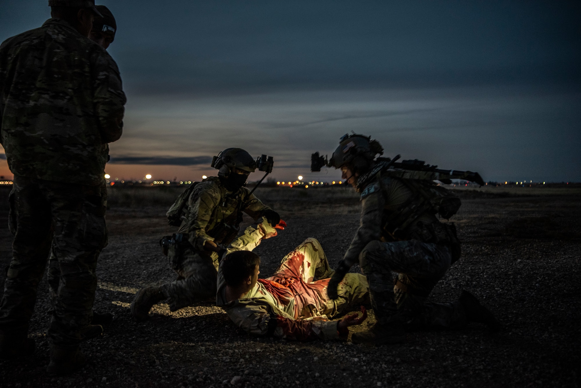 Security Forces Airmen from the 27th Special Operations Security Forces Squadron prepare to move a wounded Soldier to a safe location during a mass casualty exercise at Cannon Air Force Base, N.M., Jan. 14, 2019. The 27th SOSFS participated in a mass casualty exercise with medical personnel to train on clearing hostile locations, while escorting wounded Soldiers to safety. (U.S. Air Force photo by Airman 1st Class Gage Daniel)