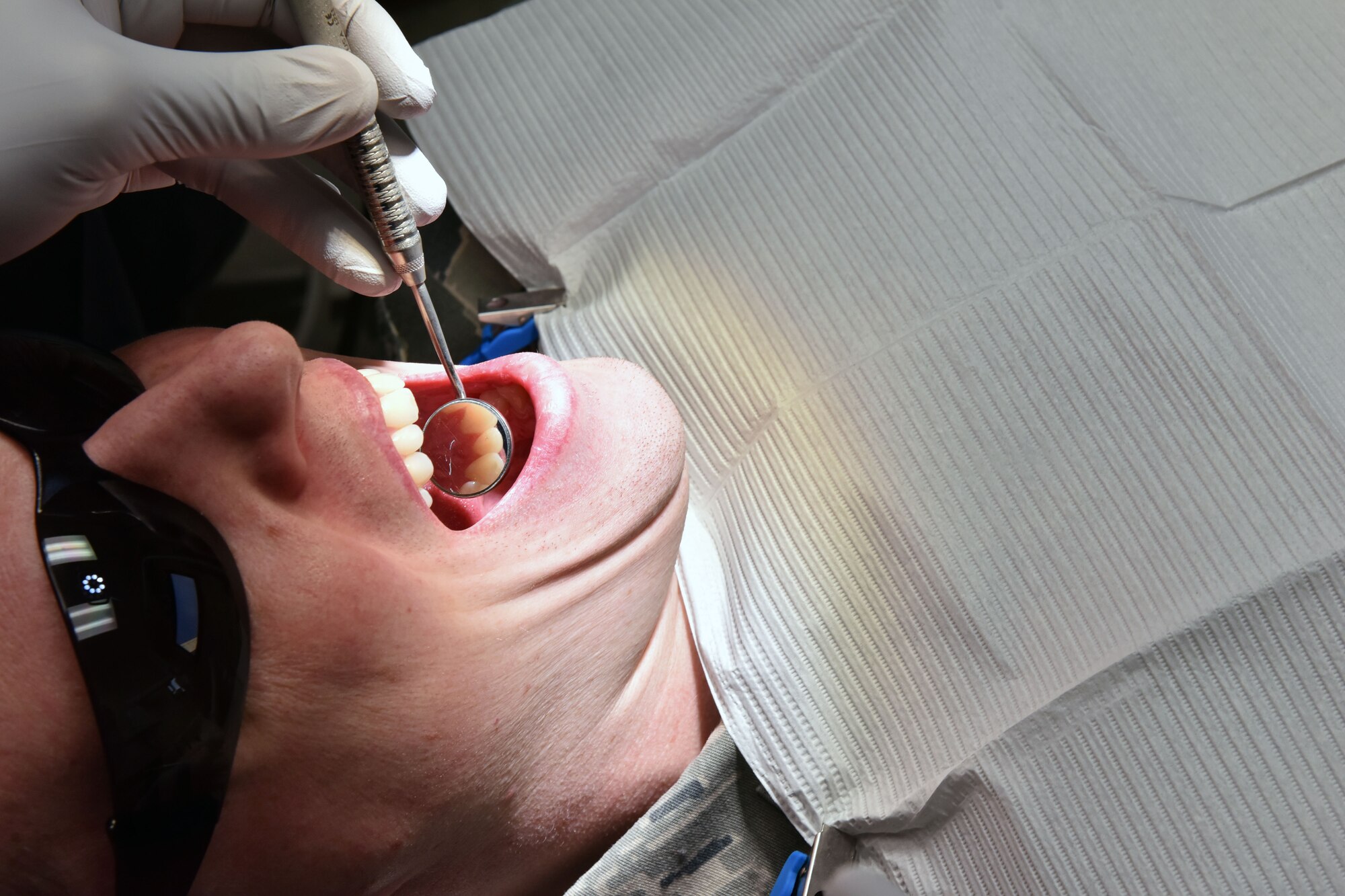 U.S. Air Force Capt. Robert Walter, a 354th Dental Flight dentist, inspects a patient’s teeth at Eielson Air Force Base, Alaska, Jan. 16, 2019. Dentistry is a vital part of keeping Airmen fit to fight, as dental conditions likely to result in a dental emergency within a year can prevent Airmen from deploying. (U.S. Air Force photo by Airman 1st Class Eric M. Fisher)