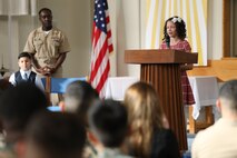 Natalie Brown, a young girl from the Camp Kinser Youth and Teen Program, recited part of Dr. Martin Luther King Jr.’s “I Have a Dream” speech during a commemorative service at Camp Kinser, Okinawa, Japan, Jan. 18, 2019. Brown was one of four youth representatives who spoke at the event. (U.S. Marine Corps photo by Cpl. Isabella Ortega)