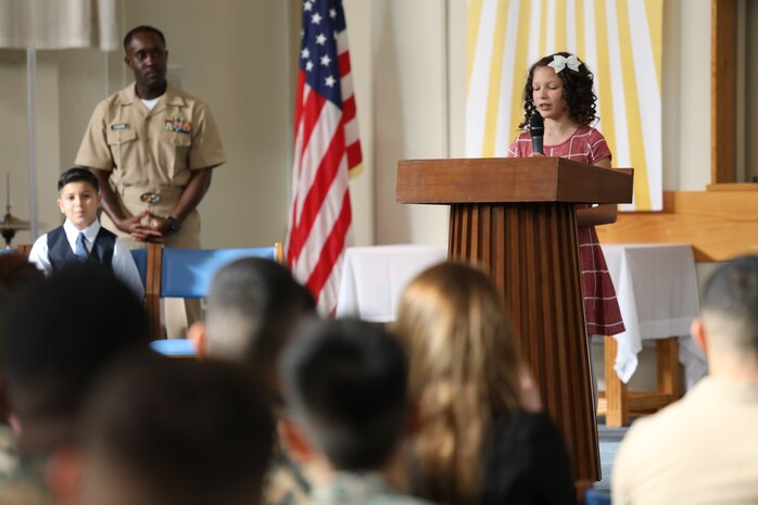 Natalie Brown, a young girl from the Camp Kinser Youth and Teen Program, recited part of Dr. Martin Luther King Jr.’s “I Have a Dream” speech during a commemorative service at Camp Kinser, Okinawa, Japan, Jan. 18, 2019. Brown was one of four youth representatives who spoke at the event. (U.S. Marine Corps photo by Cpl. Isabella Ortega)
