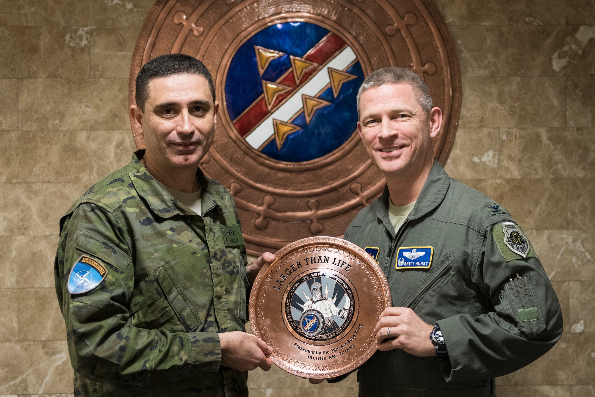 U.S. Air Force Col. Britt Hurst, 39th Air Base Wing commander, and Spanish army Lt. Col. Jose Alberto Munoz Martinez, Spanish Patriot Unit commander, pose during a going-away gift exchange at Incirlik Air Base, Turkey, Jan. 16, 2019.