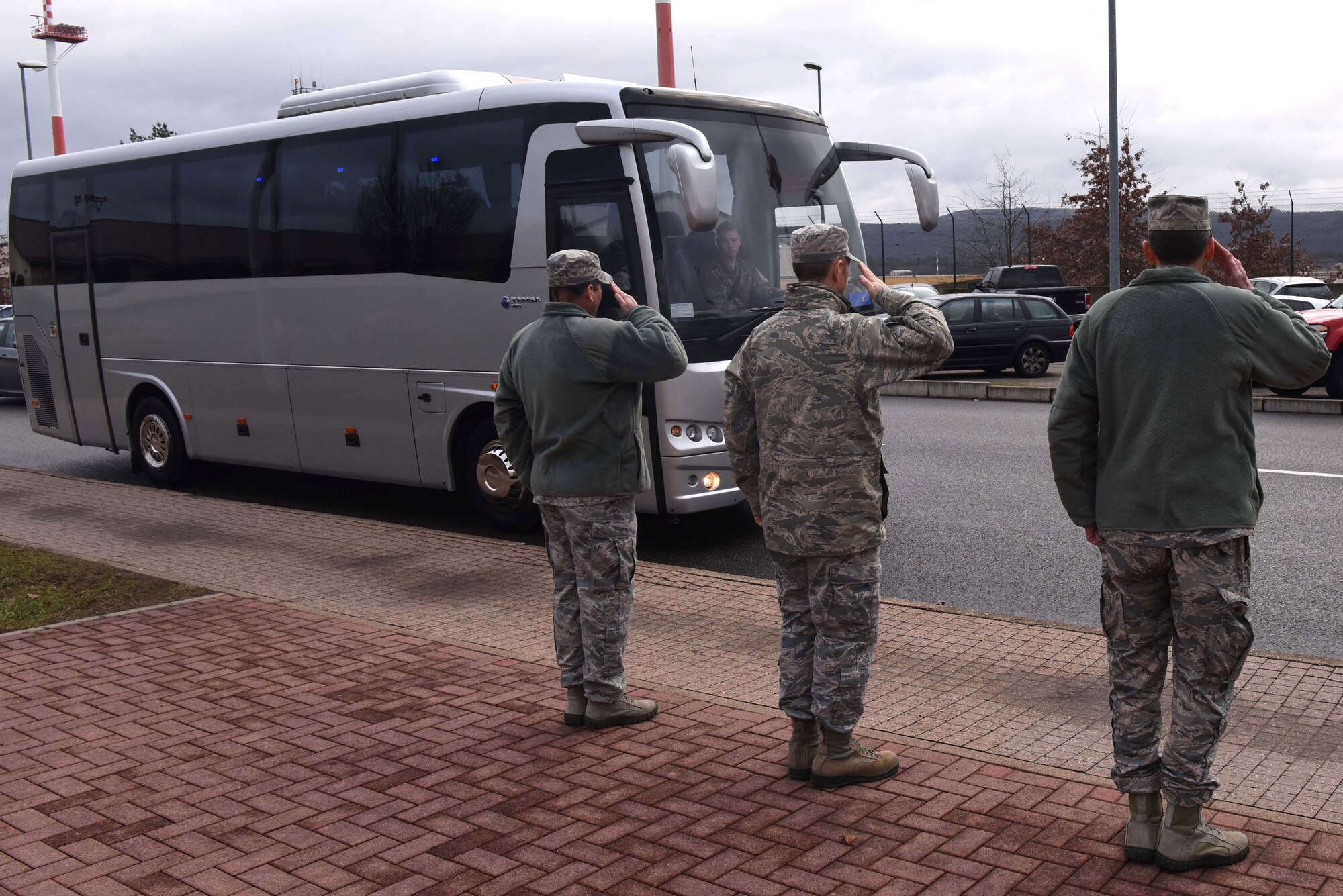 Leadership from the 521st Air Mobility Operations Wing salutes a bus arriving with Brig. Gen. John Hickok, Headquarters U.S. Air Force, mobilization assistant to the Deputy Chief of Staff for logistics, engineering and force protection, Washington, D.C., on Ramstein Air Base, Germany, Jan. 14, 2019. Hickok gave each unit the opportunity to explain their mission, and what innovations were implemented to help support it.