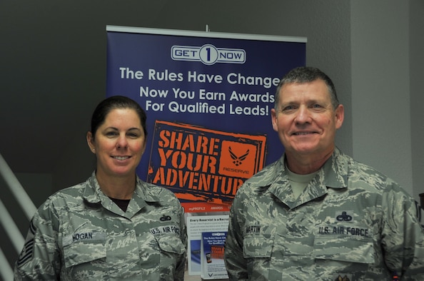 SMSgts Dominque Hogan, 403rd Wing senior recruiter and Paul Martin, 403rd Wing Inspector General Inspector superintendent pose in front of the Get1Now program sign.  Martin has submitted multiple names into the Get1Now program in order to recruit new Airmen for the Air Force Reserve.  (U.S. Air Force photo by Jessica L. Kendziorek)
