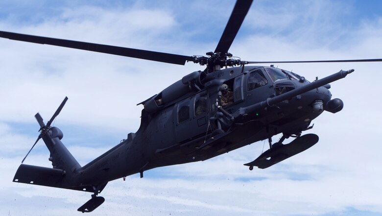 A 210th Rescue Squadron HH-60G Pave Hawk conducts hoist training June 5, 2018, at Eklutna Glacier during a fini flight for Chief Master Sgt. Lance Jordan, command chief master sergeant for the Alaska Air National Guard. The flight plan took Jordan and the HH-60G Pave Hawk crew to Six-Mile Lake and Eklutna Glacier in the Chugach Mountains. (U.S. Air National Guard photo by David Bedard/Released)