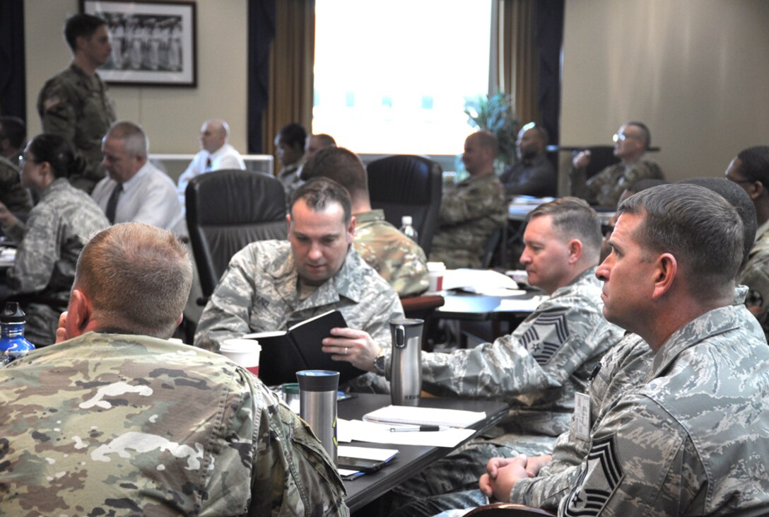 military members listen to briefings