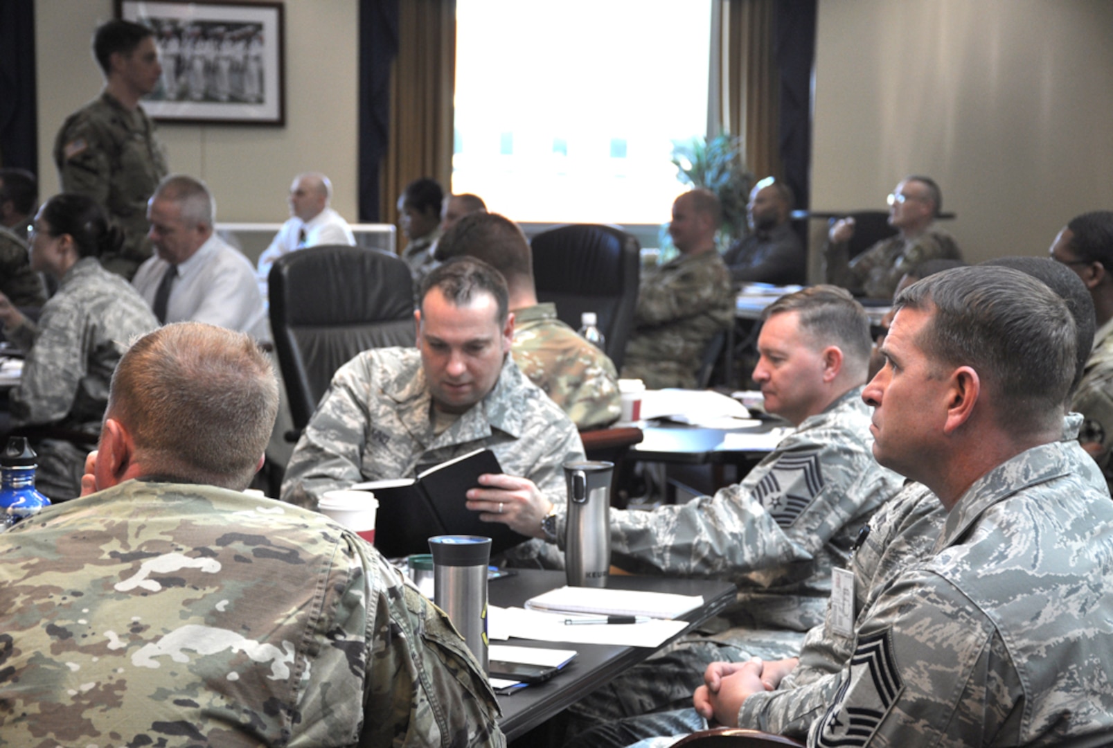military members listen to briefings