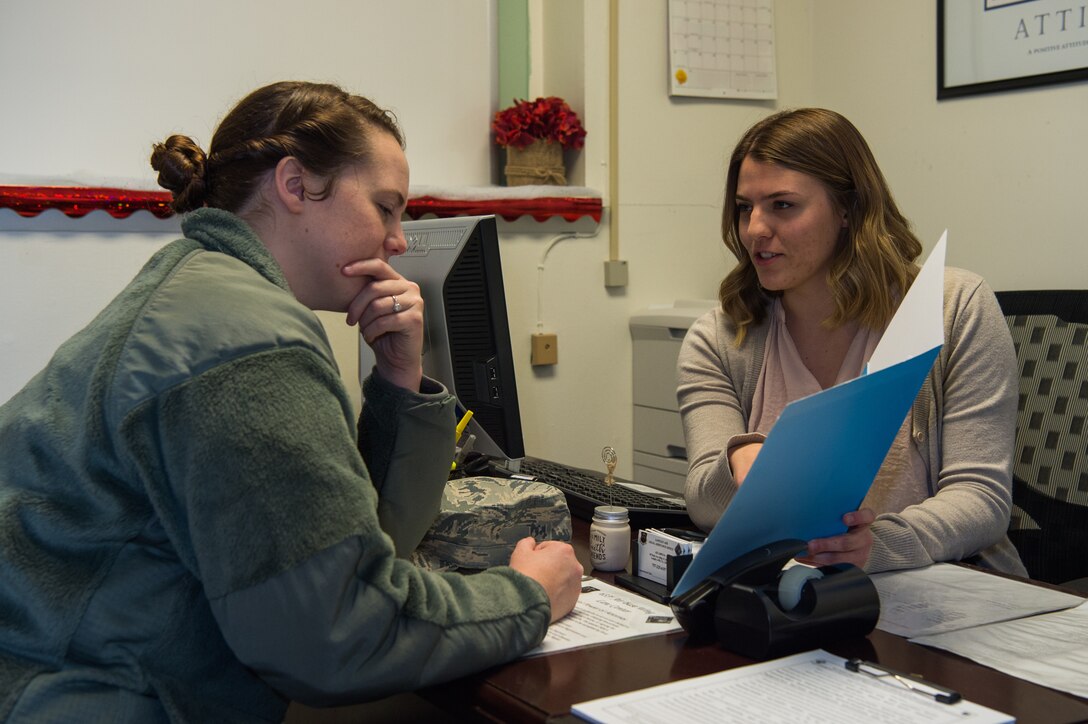 Reeana Keenen, 633rd Air Base Wing Judge Advocate extern, (right) helps U.S. Air Force Airman Casey Shahan, 633rd Air Base Wing Judge Advocate paralegal, with her taxes at Joint Base Langley-Eustis, Virginia, Jan. 18, 2019.