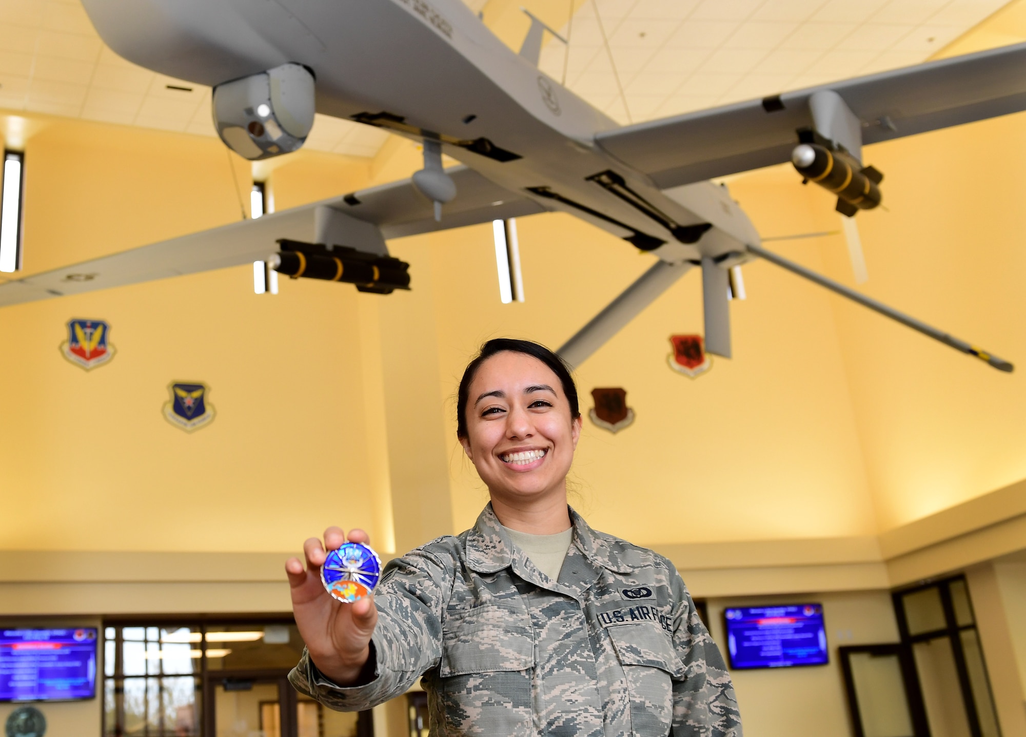 U.S. Air Force 78th Attack Squadron aviation resource manager, shows the coin she received from U.S. Air Force Lt. Gen. Joseph Guastella, U.S. Air Forces Central Command commander, at Creech Air Force Base, Nevada, Jan. 16, 2019. Guastella coined several 432nd Wing/432nd Expeditionary Wing and 799th Air Base Group outstanding Airmen. (U.S. Air Force photo by Senior Airman Christian Clausen)