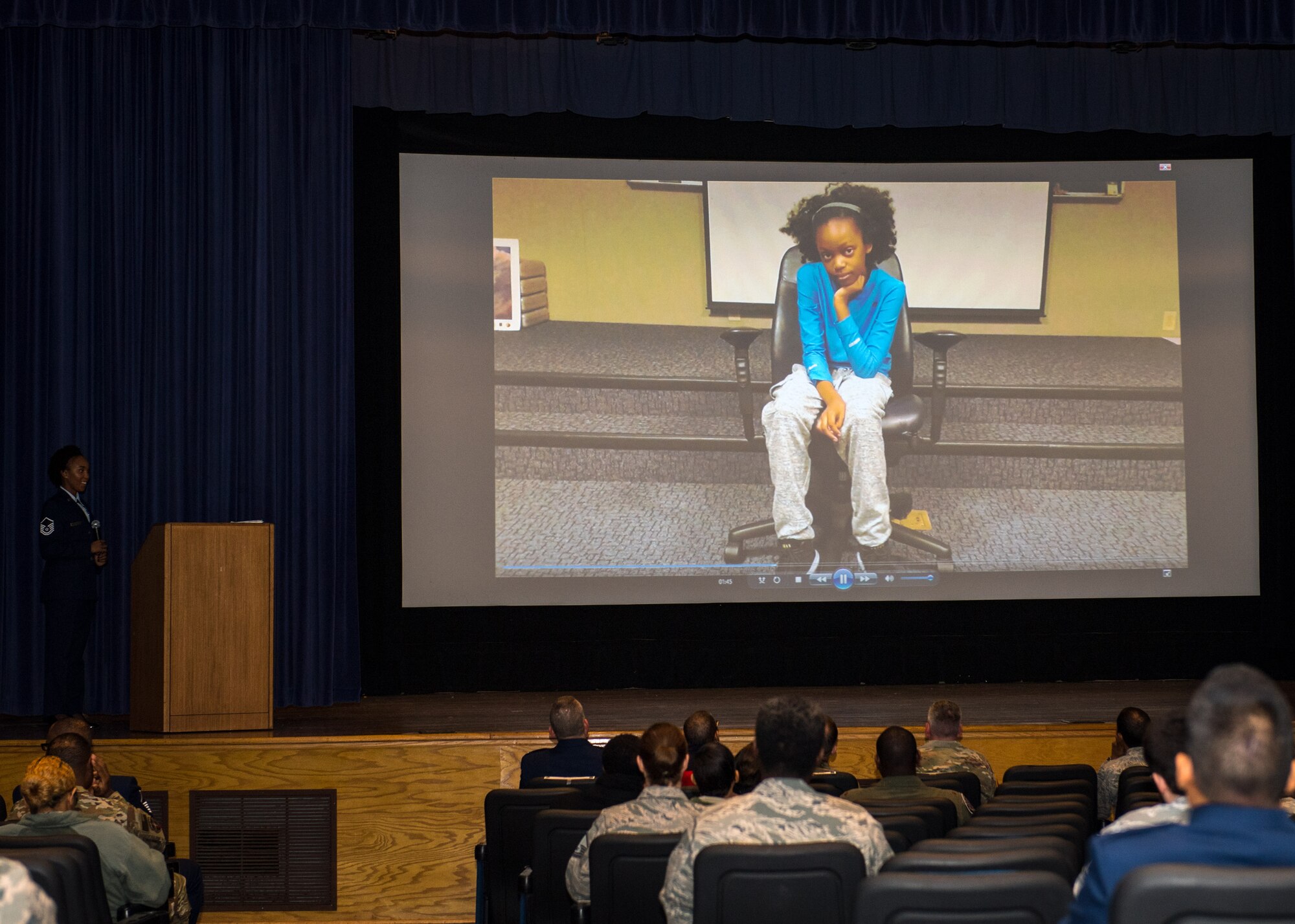 A video plays demonstrating what kids think voting is about during a Dr. Martin Luther King Jr. celebration at Joint Base Langley-Eustis, Virginia, Jan. 18, 2019.