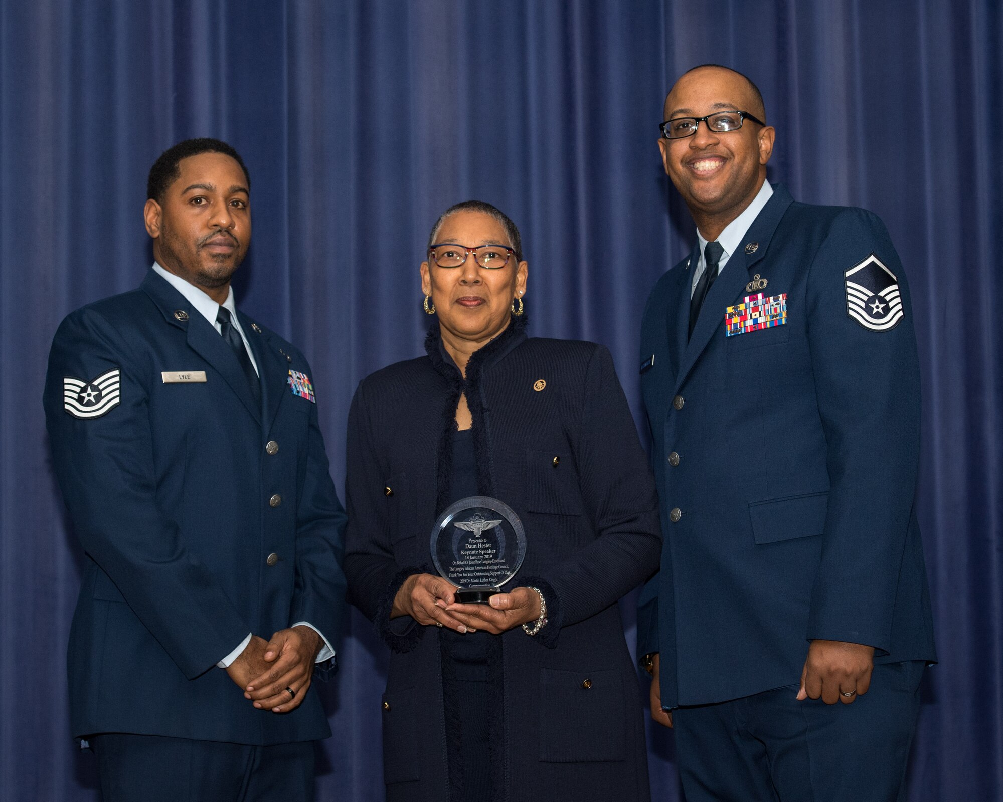 U.S. Air Force Tech. Sgt. Toure Lyle, Langley African American Heritage Council president and Master Sgt. Terrell Duckworth, LAAHC parliamentarian, present a gift to keynote speaker Daun Hester, City of Norfolk treasurer, during a Dr. Martin Luther King Jr. celebration at Joint Base Langley-Eustis, Virginia, Jan. 18, 2019.