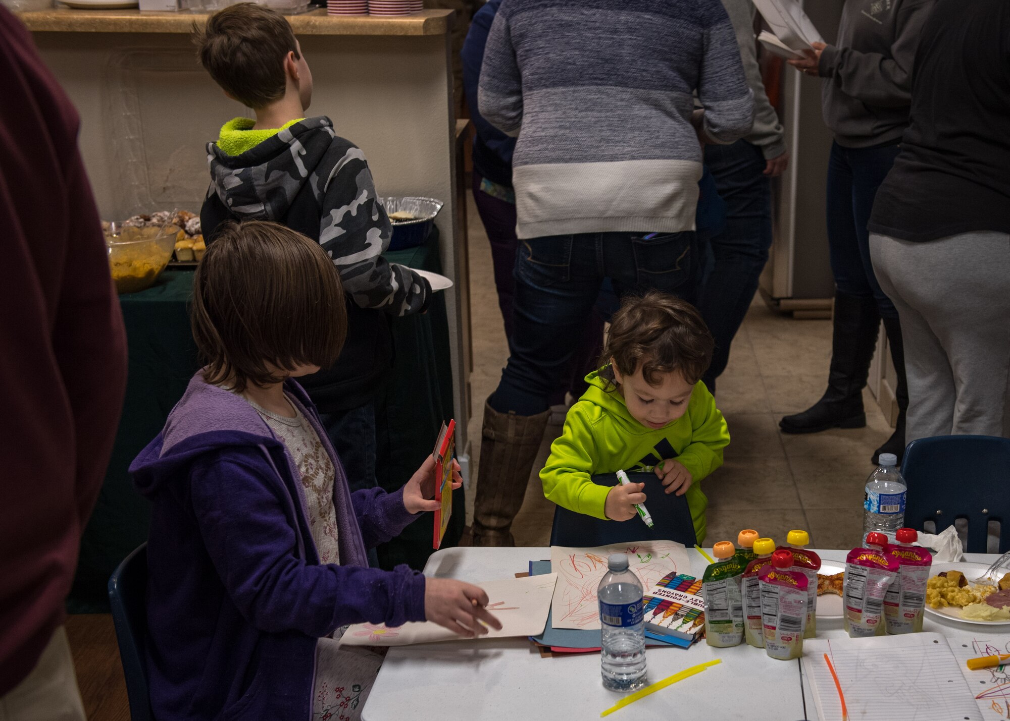 Children draw and color on sheets of paper at Jamestown Village, Yorktown, Virginia, Jan. 15, 2019.