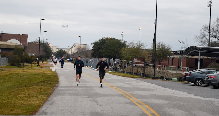 Senior Airman Will Merriman (left), 315th Force Support Squadron knowledge management specialist, and Senior Airman Alberto Castillo (right), 437th Maintenance Squadron crew chief, lead the pack of runners Jan. 18, 2019, during the Martin Luther Jr. 5k run at Joint Base Charleston, S.C.