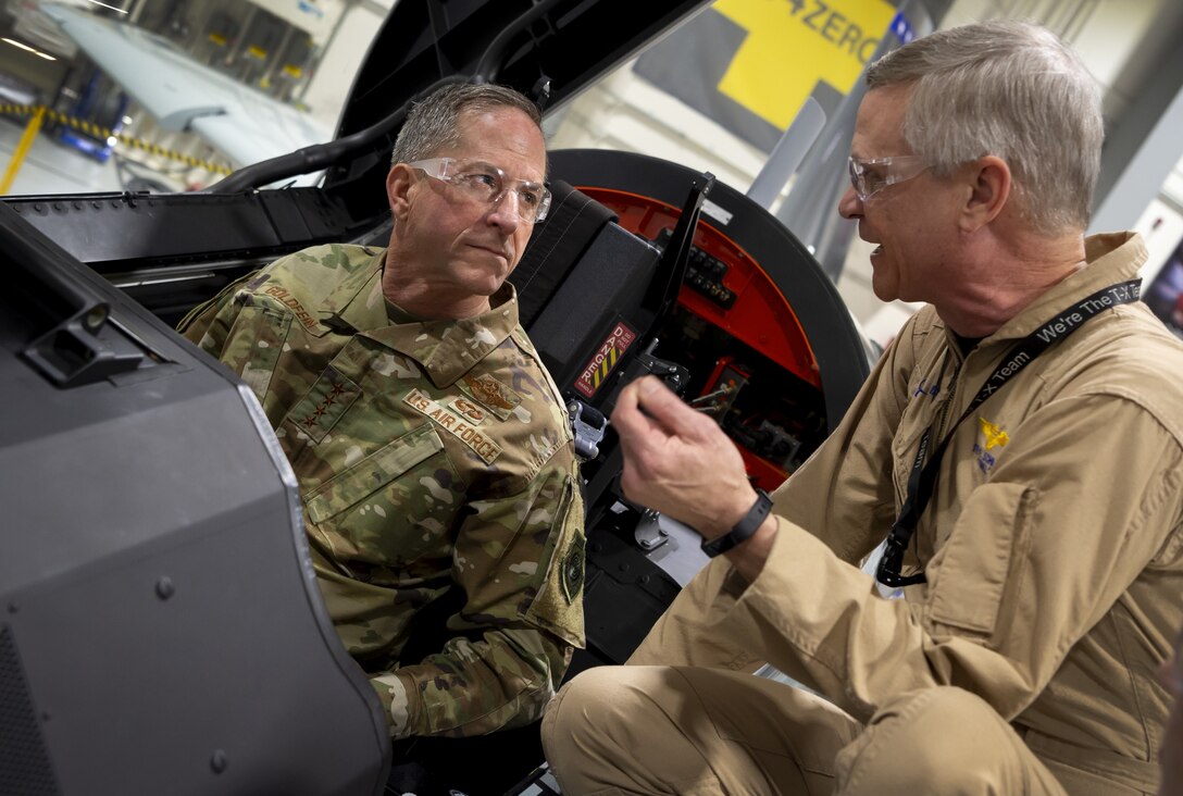 Boeing test pilot Steve Schmidt explains features of the new T-X trainer to Air Force Chief of Staff Gen. David L. Goldfein as Goldfein sits in the plane’s elevated instructor’s seat. Goldfein inspected the plane during a visit Jan. 15 to Boeing’s St. Louis production facility.(Boeing photo)