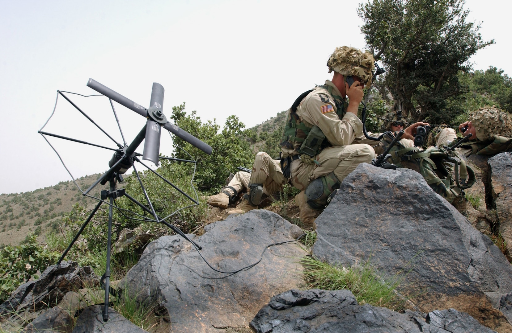 Soldier from 3/187th Infantry, 101st Airborne Division, out of Fort Campbell, Kentucky, sets up SATCOM to communicate further with key rear elements as part of search and attack mission in area of Narizah, Afghanistan, July 23, 2002 (U.S. Army/Todd M. Roy)