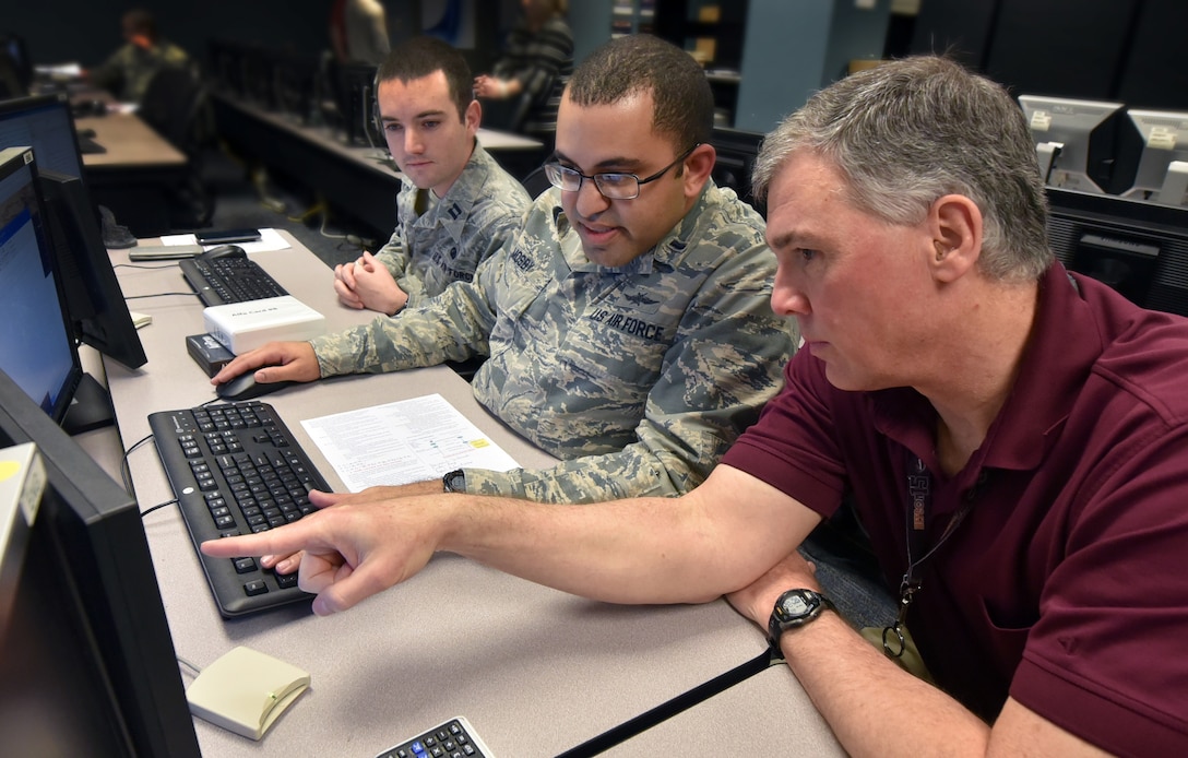 Air Force Institute of Technology students listen as professor (right) explains hacking technique during class at Wright-Patterson Air Force Base, Ohio,
February 20, 2018 (U.S. Air Force/Al Bright)