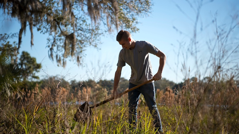U.S. Air Force Airman 1st Class Gabriel Welsch, a 6th Medical Support Squadron radiology student, digs a hole before planting a tree during the Arbor Day observance at MacDill Air Force Base, Fla., Jan. 18, 2019. Arbor Day is an international holiday that recognizes the importance of trees and promotes citizens to take part in maintaining the urban forests in their community by planting trees.