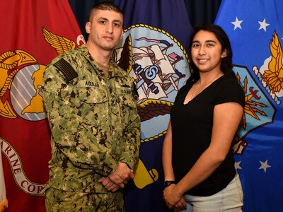 Petty Officer 1st Class Ivan Aguilar of Pharr, Texas, poses for a photo with his sister, Lesley Torres, of Edinburg, Texas, after Torres took the oath of enlistment at the San Antonio Military Entrance Processing Station.  Aguilar is a division leading petty officer assigned to Navy Recruiting Station McAllen, Navy Recruiting District San Antonio and helped enlist his sister into the Navy. Torres, a 2018 graduate of Edinburg North High School, is the third of three siblings and the first female in her family to serve in the military.