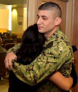 Petty Officer 1st Class Ivan Aguilar of Pharr, Texas, embraces his sister, Lesley Torres, of Edinburg, Texas, after Torres took the oath of enlistment at the San Antonio Military Entrance Processing Station.  Aguilar is a division leading petty officer assigned to Navy Recruiting Station McAllen, Navy Recruiting District San Antonio and helped enlist his sister into the Navy.  Torres, a 2018 graduate of Edinburg North High School, is the third of three siblings and the first female in her family to serve in the military.