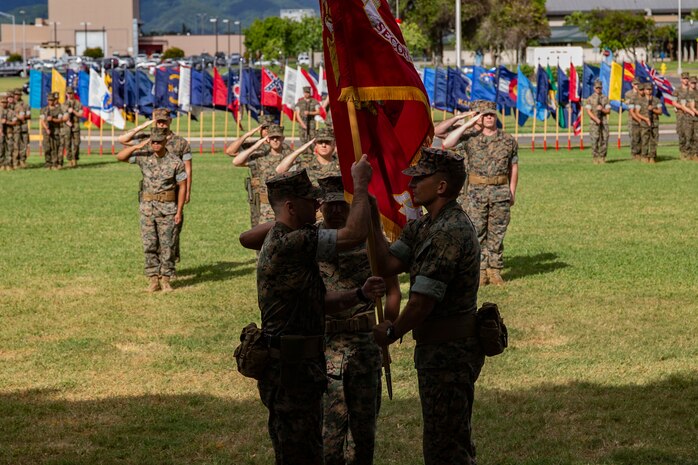 U.S. Marine Corps Lt. Col. Serge Morosoff, off-going commanding officer, 2nd Battalion, 3d Marine Regiment passes the colors to Lt. Col. Christopher McGuire, on-coming commanding officer, during the battalion's change of command ceremony aboard Marine Corps Base Hawaii, Jan. 17, 2019. Lt. Col. Serge Morosoff relinquished command to Lt. Col. Christopher P. McGuire. (U.S. Marine Corps photo by Sgt. Alex Kouns/Released)