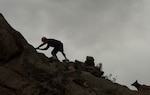 Air Force pararescueman climbs mountain as his dog Kai waits during Adaptive Sports Camp in Crested Butte, Colorado, February 8, 2016 (U.S. Air Force/Vernon Young, Jr.)