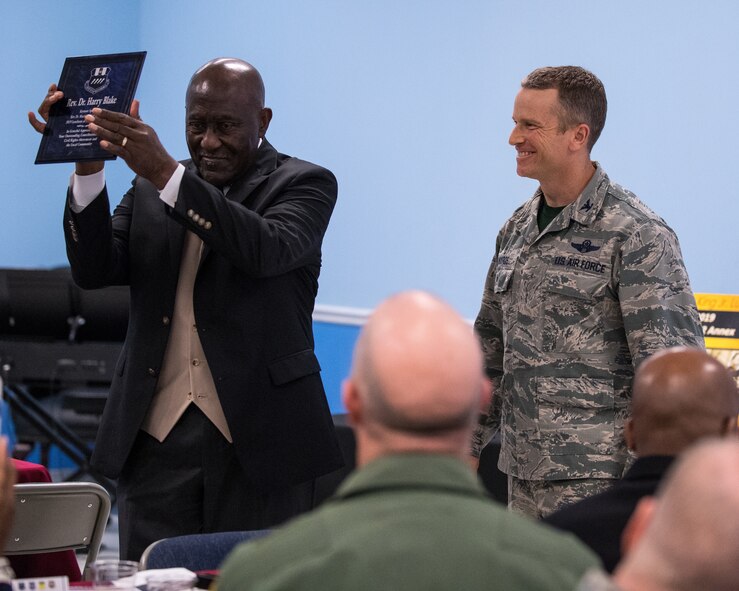 Col. Rob Makros, 2nd Bomb Wing vice commander, thanks Rev. Dr. Harry Blake, local civil rights pioneer, for his time and dedication with a plaque at Barksdale Air Force Base, La., Jan. 18, 2019. Blake served as the first field secretary of the Southern Christian Leadership Conference under the guidance of Martin Luther King Jr. (U.S. Air Force photo by Airman 1st Class Lillian Miller)