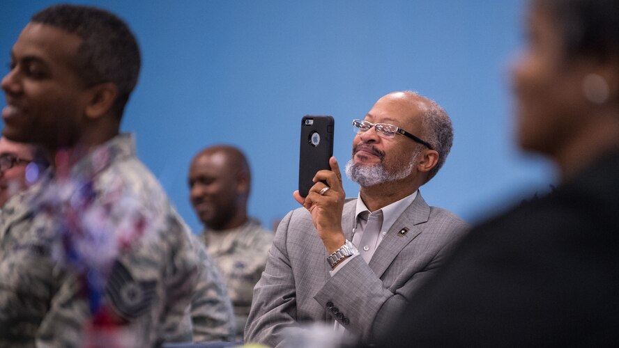 An audience member smiles while recording a speech given by local civil rights pioneer, Rev. Dr. Harry Blake at Barksdale Air Force Base, La., Jan. 18, 2019. Blake served with Martin Luther King Jr. in the Southern Christian Leadership Conference. (U.S. Air Force photo by Airman 1st Class Lillian Miller)