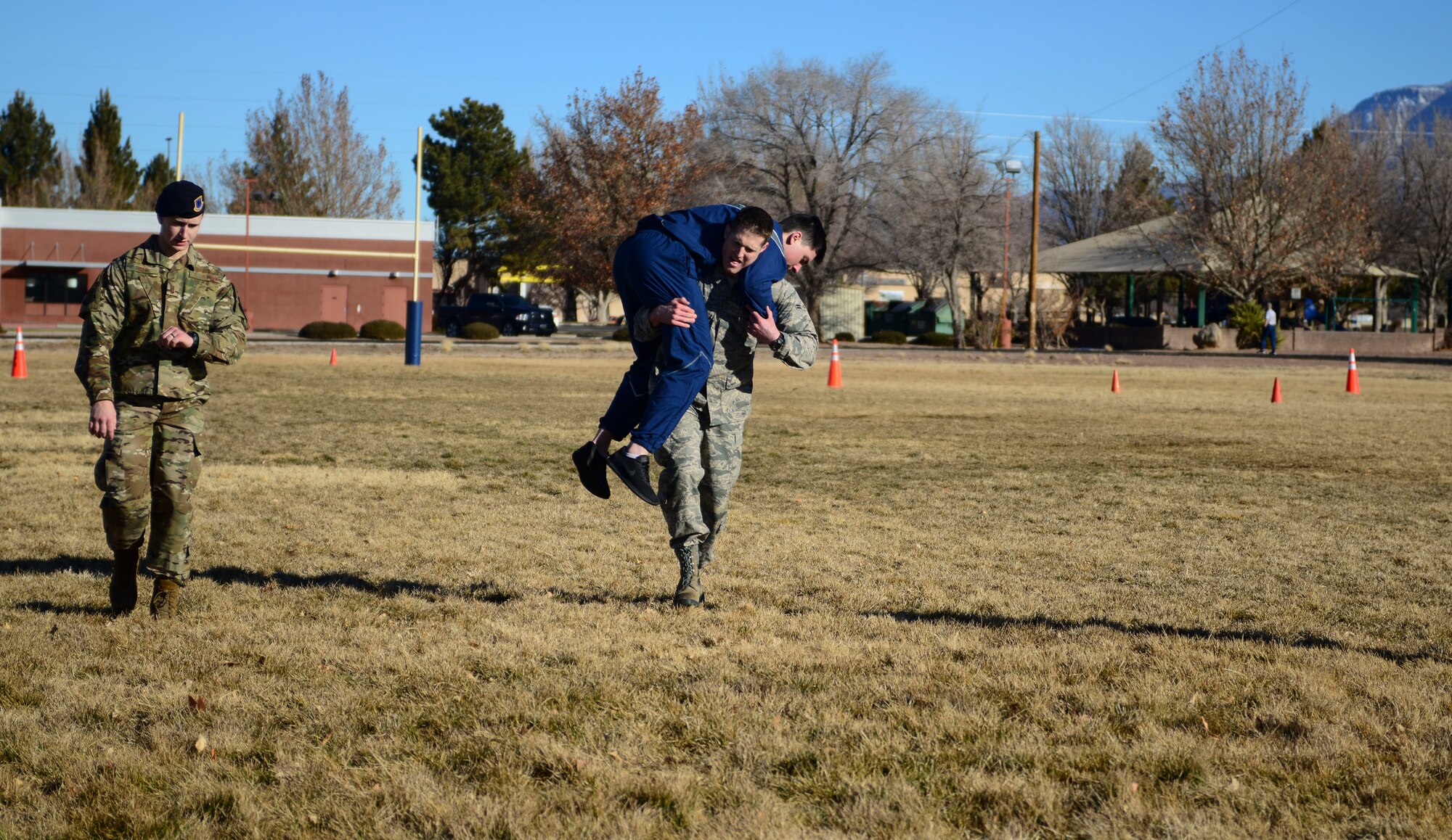 Airmen take part in the fireman carry maneuver
