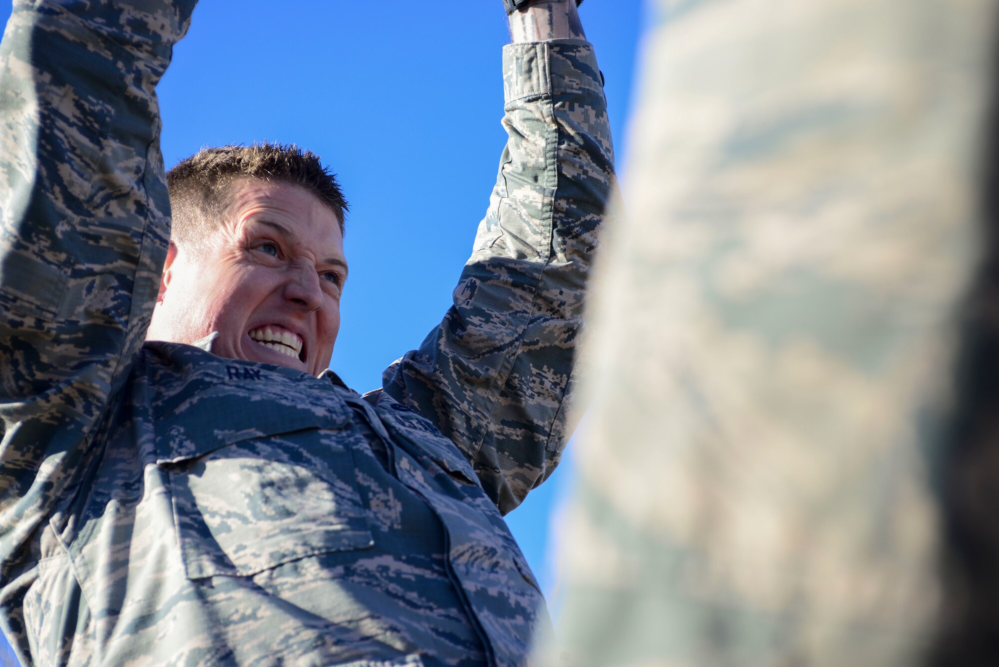 Airman lifts ammunition can above head