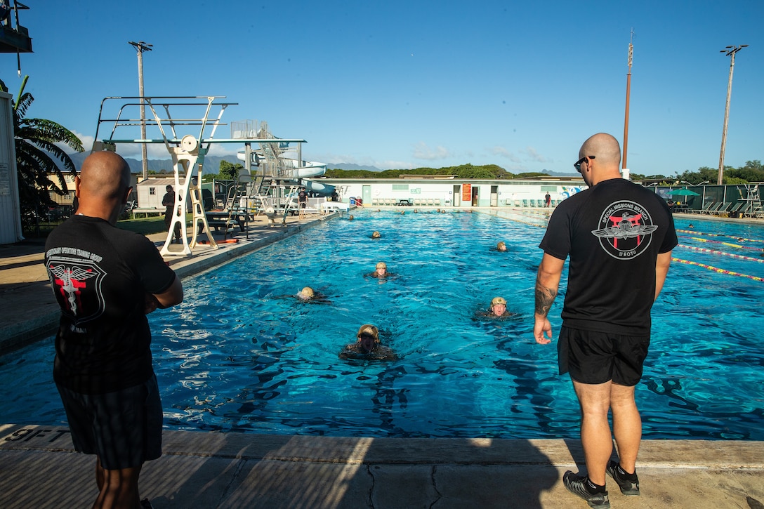 Instructors with the III Marine Expeditionary Force Expeditionary Operations Training Group watch Marines with 31st Marine Expeditionary Unit's Maritime Raid Force swim during Visit, Board, Search and Seizure training at Marine Corps Base Hawaii, Kaneohe Bay, Hawaii, Jan. 7, 2019. Reconnaissance Marines with MRF train for quick, tactical raids of moving vessels, launched from both land and sea. The 31st MEU, the Marine Corps’ only continuously forward-deployed MEU, provides a flexible and lethal force ready to perform a wide range of military operations as the premier crisis response force in the Indo-Pacific region. (U.S. Marine Corps photo by Cpl. Isaac Cantrell)