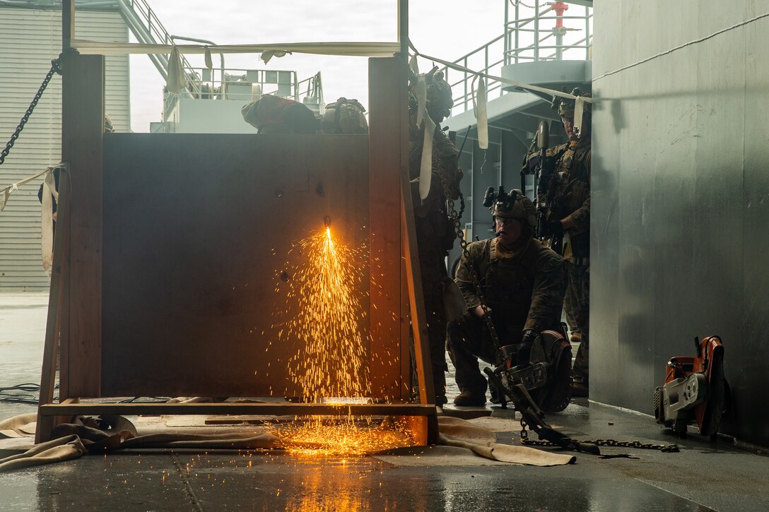 Marines with the 31st Marine Expeditionary Unit's Maritime Raid Force breach an entrance aboard a simulated non-compliant vessel during Visit, Board, Search and Seizure training at Marine Corps Base Hawaii, Kaneohe Bay, Hawaii, Jan. 15, 2019. Force Reconnaissance Marines with MRF train for quick tactical raids of moving vessels, launched from both land and sea. The 31st MEU, the Marine Corps’ only continuously forward-deployed MEU, provides a flexible and lethal force ready to perform a wide range of military operations as the premier crisis response force in the Indo-Pacific region. (U.S. Marine Corps photo by Cpl. Isaac Cantrell/Released)