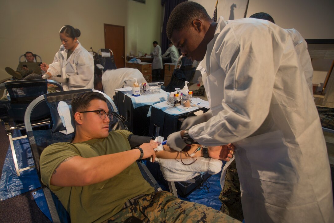 Cpl. Johnny Dao, a cyber systems operator, with the 31st Marine Expeditionary Unit, volunteers to give blood during a blood drive at Camp Hansen, Okinawa, Japan, Jan. 14, 2019. Marines were encouraged to donate blood for the upcoming exercise Cobra Gold. The 31st MEU, the Marine Corps’ only continually forward-deployed MEU, provides a flexible force ready to perform a wide range of military operations as the premier crisis response force in the Indo-Pacific region. (U.S. Marine Corps photos by Lance Cpl. Cameron Parks/ Released)