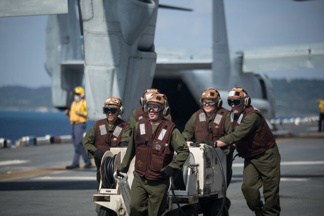 Marines with the Marine Medium Tiltrotor Squadron 262 (Reinforced) move machinery on the flight deck aboard the amphibious assault ship USS Wasp (LHD-1) at sea, Jan. 18, 2019. VMM-262 (Rein.) is the Aviation Combat Element for the 31st Marine Expeditionary Unit. Its naval aviators fly the MV-22B Osprey tiltrotor aircraft, as well as a variety of other rotary and fixed-wing aircraft. The 31st MEU, the Marine Corps’ only continuously forward-deployed MEU partnering with the Wasp Amphibious Ready Group, provides a flexible and lethal force ready to perform a wide range of military operations as the premier crisis response force in the Indo-Pacific region. (U.S. Marine Corps photo by Lance Cpl. Kyle P. Bunyi/ Released)