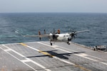 U.S. Navy file photo of a C-2A Greyhound as it lands on the flight deck of a Nimitz-class aircraft carrier.