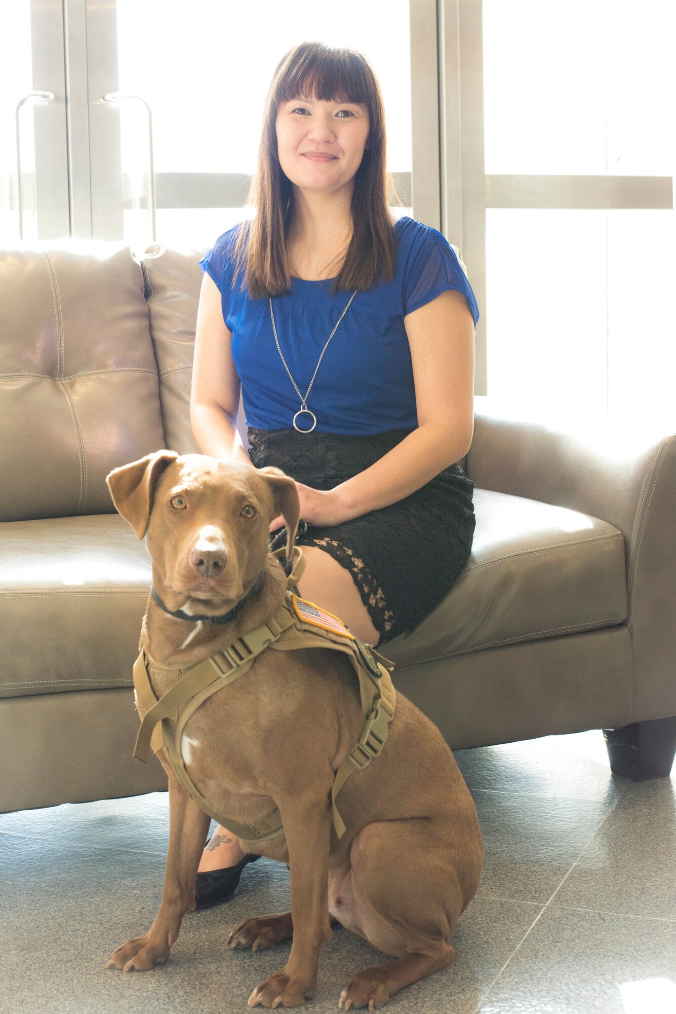 Jen Wong, 374th Force Support Squadron, Exceptional Family Member Program Family support coordinator, poses for a portrait with her service dog, Casey at Yokota Air Base, Japan, Jan.18, 2019.