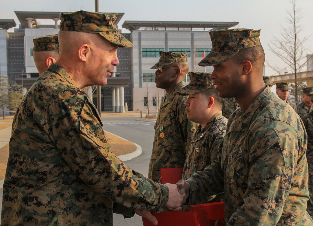 CAMP HUMPHREYS, Republic of Korea – Staff Sgt. Anthony J. Kirby, U.S. Marine Corps Forces Korea communication strategy and future operations chief, receives the Navy and Marine Corps Achievement Medal from Maj. Gen. Patrick J. Hermesmann, MARFORK commander, here, Jan. 22. Kirby received the award for developing the command’s COMMSTRAT and future operations capabilities. (Official U.S. Marine Corps photos by Sgt. Nathaniel Hanscom/Released)