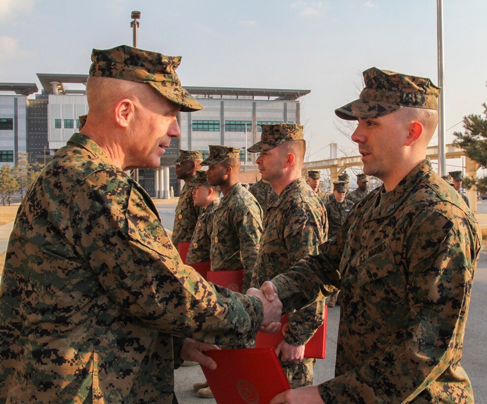CAMP HUMPHREYS, Republic of Korea – Sgt. Craig Richie, U.S. Marine Corps Forces Korea G-6 help desk chief, receives a Certificate of Commendation from Maj. Gen. Patrick J. Hermesmann, MARFORK commander, here, Jan. 22. Richie earned MARFORK Non-Commissioned Officer of the Quarter for his professional example and contribution to the unit’s mission accomplishment. (Official U.S. Marine Corps photos by Sgt. Nathaniel Hanscom/Released)