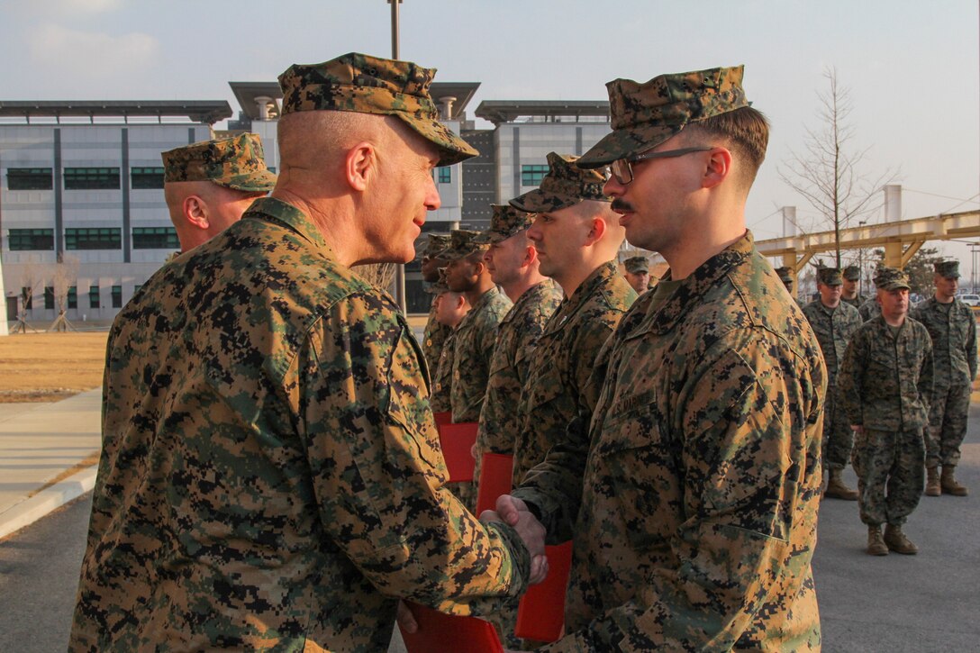 CAMP HUMPHREYS, Republic of Korea – Lance Cpl. Jordan Clark, U.S. Marine Corps Forces Korea plans and policy force deployment planning & execution specialist, receives a Certificate of Commendation from Maj. Gen. Patrick J. Hermesmann, U.S. Marine Corps Forces Korea commander, here, Jan. 22. Clark earned Marine of the Quarter for his professional example and contribution to the accomplishment of the MARFORK mission. (Official U.S. Marine Corps photos by Sgt. Nathaniel Hanscom/Released)