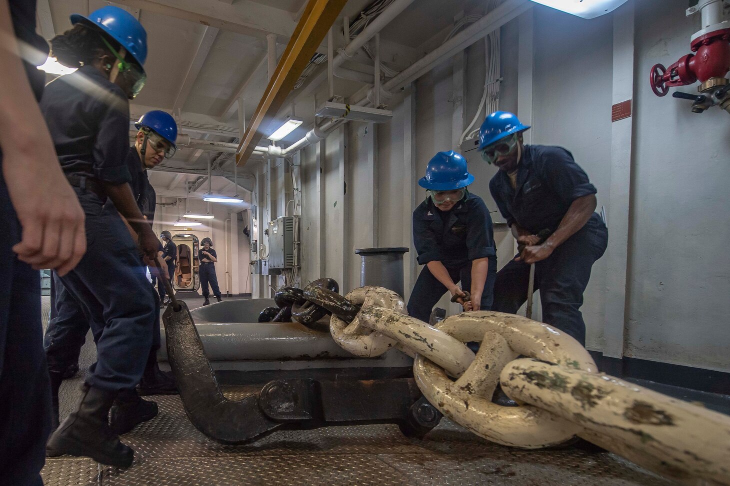 Sailors prepare to insert a stopper on an anchor chain in the forecastle of Wasp-class amphibious assault ship USS Essex (LHD 2) while anchoring off the coast of Phuket, Thailand during a  deployment of the Essex Amphibious Ready Group (ARG) and 13th Marine Expeditionary Unit (MEU). The Essex ARG/13th MEU is deployed to the U.S. 7th Fleet area of operation to support regional stability, reassure partners and allies and maintain a presence postured to respond to any crisis ranging from humanitarian assistance to contingency operations.