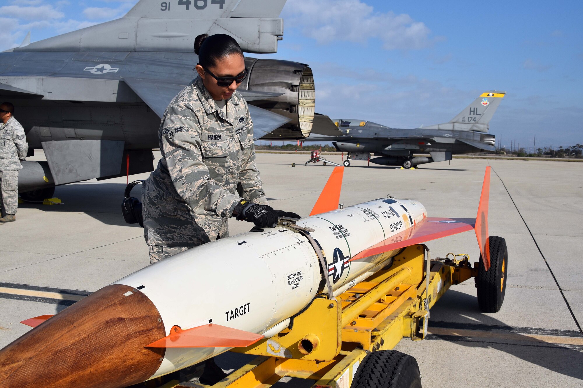 Airman 1st Class Cierra-Mae Hanson, 412th Maintenance Group, inspects an AQM-37D supersonic target before it is loaded on to an Edwards Air Force Base F-16 at Naval Air Station Point Mugu, California, Nov. 28, 2018. Two F-16s, a KC-135 Stratotanker, and maintenance Airmen from Edwards assisted the U.S. Navy and Royal Australian Navy with a test of a Royal Australian Navy ship’s combat system late last year. (U.S. Navy photo by BU3 Dakota Fink)