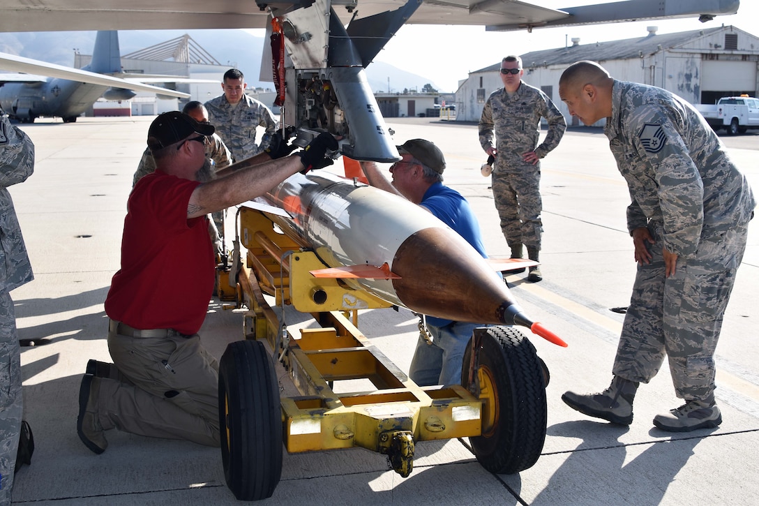 Airmen from the 412th Maintenance Group are assisted by members of the Naval Air Warfare Center Weapons Division's Threat/Targets Department at Naval Air Station Point Mugu, California. They are loading an AQM-37D supersonic target, Nov. 28, 2018. Two F-16s, a KC-135 Stratotanker, and maintenance Airmen from Edwards assisted the U.S. Navy and Royal Australian Navy with a test of a Royal Australian Navy ship’s combat system late last year. The Point Mugu team consisted of Lee Cobb, Tad Miller and Jeremy Gibson. (U.S. Navy photo by BU3 Dakota Fink)