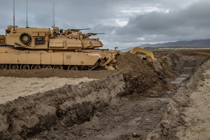 A U.S. Marine Corps assault breacher vehicle with 1st Combat Engineer Battalion, 1st Marine Division, fills a trench during a simulated amphibious assault at Marine Corps Base Camp Pendleton, California, Jan. 12, 2019.
