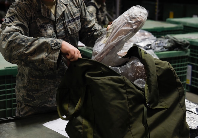 An Airman repacks his issued equipment during a pre-deployment function line exercise Jan. 23, 2019, at Joint Base Charleston, S.C.