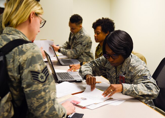 Airman 1st Class Mavis Amankwah, 628th Force Support Squadron customer support technician, assists deploying Airmen during a pre-deployment function line training Jan. 23, 2019, at Joint Base Charleston, S.C.