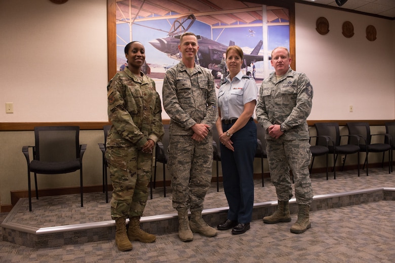 (Left to Right) Major Shawna Parker, deputy director of revitalizing squadrons task force, Col. Russell Williford, director of revitalizing squadrons task force, Col. Heather Thorne-Albright, Royal Canadian Air Force family advocate, and Chief Master Sgt. Johnathan Hover, chief of revitalizing squadrons task force, pose for a group photo at Luke Air Force Base, Ariz., Jan. 17, 2019. The task force visited Luke to promote practices and identify improvements which need to be made in achieving squadron revitalization initiatives. (U.S. Air Force photo by Senior Airman Caleb Worpel)