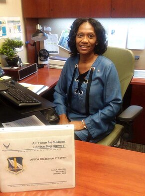 Carla Perkins proudly wears her Change Agent pin. Perkins is a clearance reviewer and business advisor for the 772nd Enterprise Sourcing Squadron Defense Environment Restoration Program. With her extensive background and experience in acquisition procedural guidance, she recently identified acceptable solutions to resolve issues that came up and made corrections to acquisition requirement packages in support of two critical multi-million dollar acquisitions in support of the Air Force Civil Engineer Center.  (Courtesy photo)