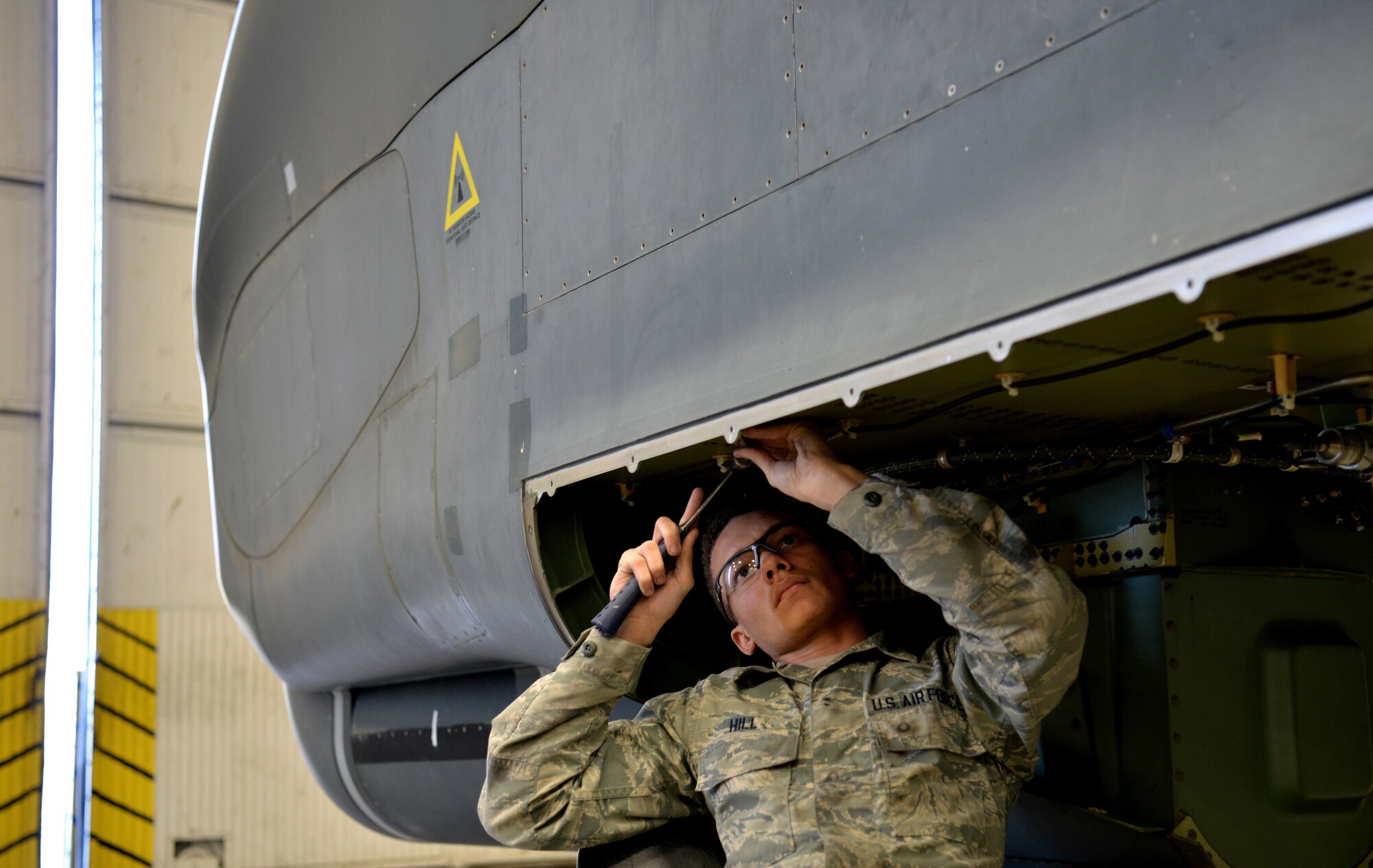 Airman 1st Class Gregory Hill, 9th Maintenance Squadron aircraft structural maintenance technician, shapes a part on an RQ-4 Global Hawk