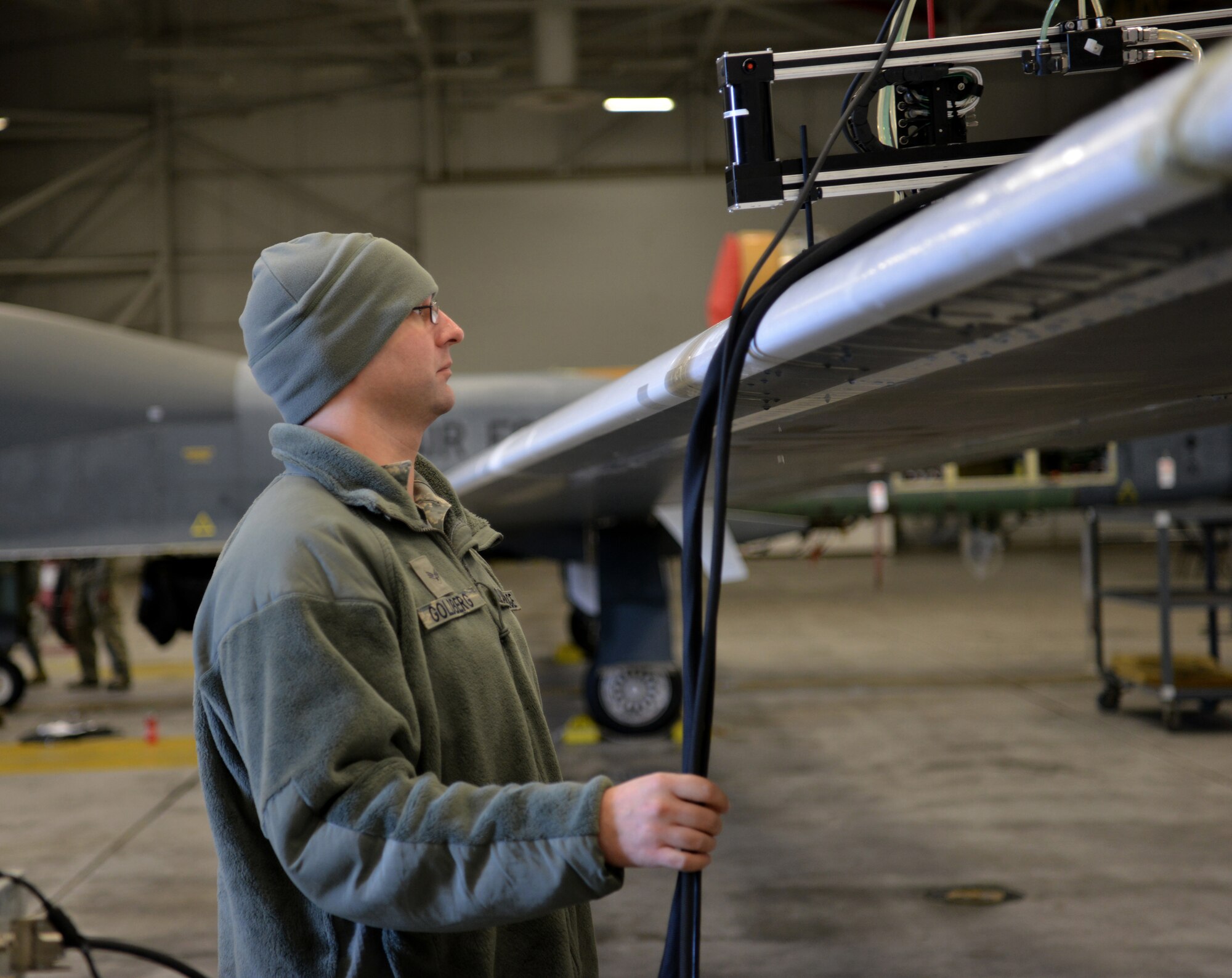 Senior Airman Joseph Goldberg, 9th Maintenance Squadron non-destructive inspection (NDI) technician, observes a ultrasound scan on an RQ-4 Global Hawk
