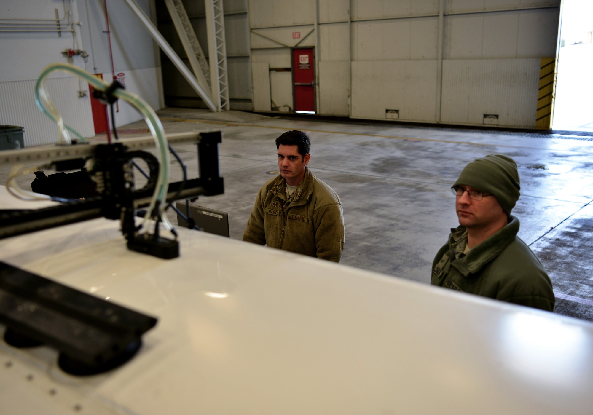 Airmen from the 9th Maintenance Squadron non-destructive inspection (NDI) technicians, observe a ultrasound scan on an RQ-4 Global Hawk