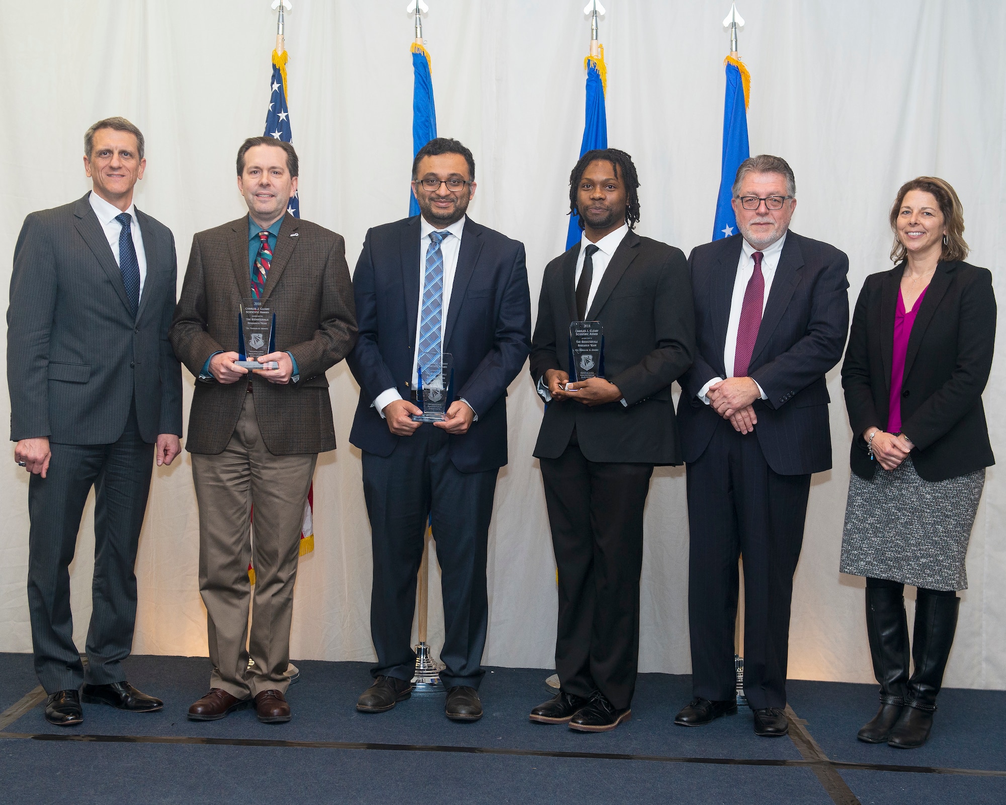 The Materials and Manufacturing Directorate’s most prestigious award at the 66th  annual awards luncheon is the Charles J. Cleary Scientific Award. The winner is the Biomaterials Research Team. Shown left to right Timothy Sakulich, (team members: Dr. Patrick Dennis, Dr. Maneesh Gupta, Marquis Crosby), Michael Cleary and Dr. Wendy Goodson. (U.S. Air Force photo/Rich Oriez)