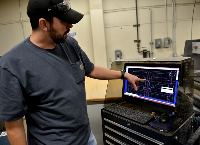 Jacob Schargus, 9th Maintenance Squadron aircraft technology work lead, plots a cutting pattern